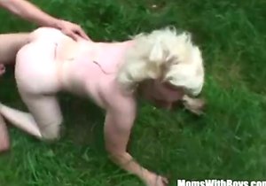 Outdoor fucking with a submissive MILF in the grass