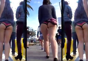 Stunning brunette with a good round booty walks outdoors
