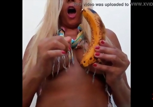 Beautiful soloing mature eats a big banana in a hot way